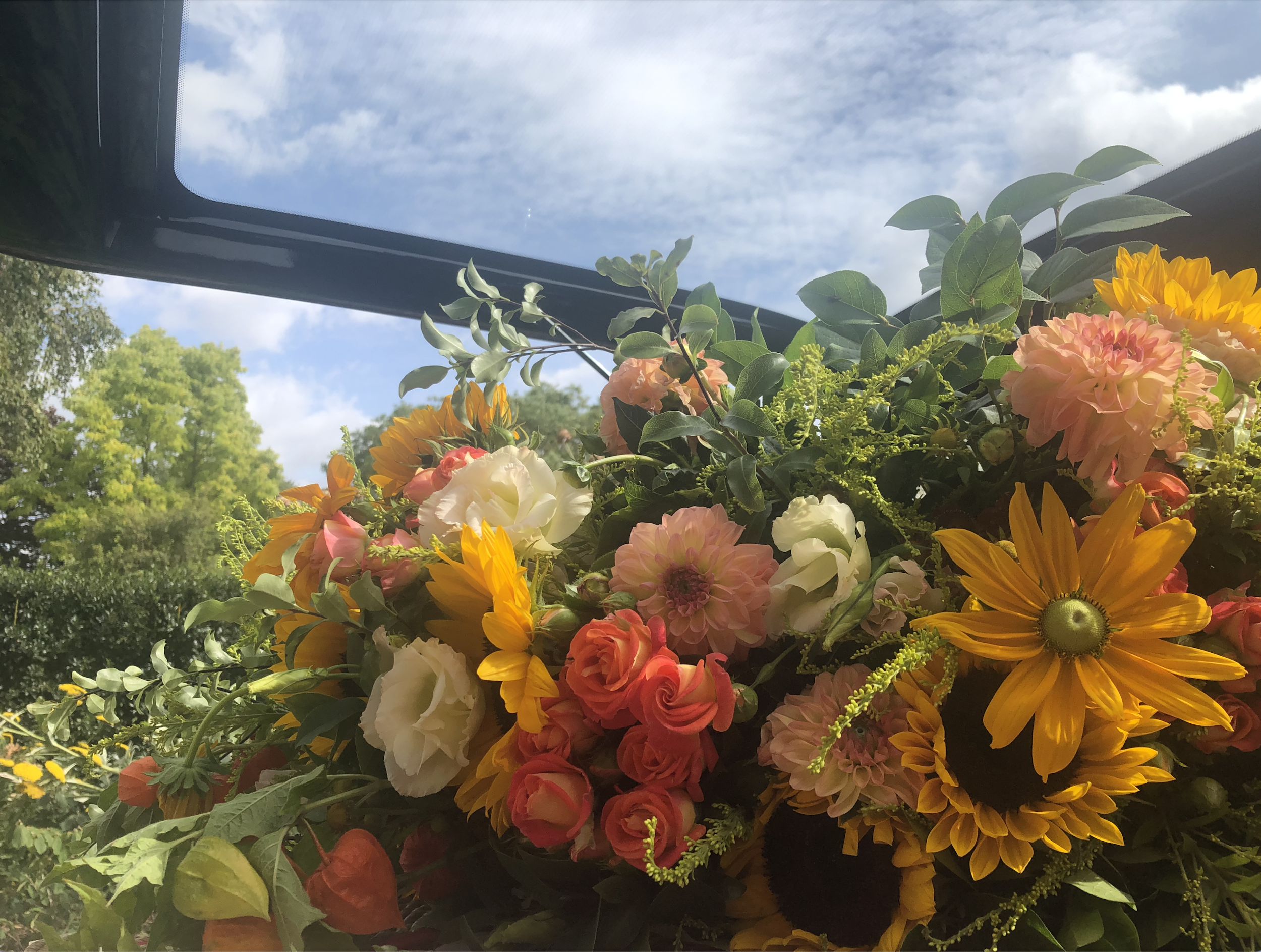 Sunflowers and colourful funeral flowers chosen to remember Simon