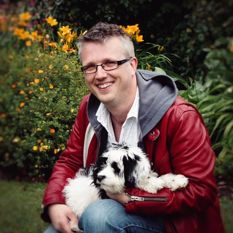 Portrait of Trevor Donnelly outdoors in a red jacket