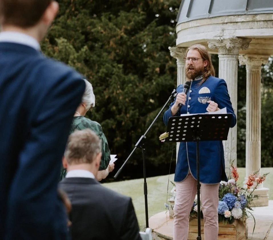 Sanderson Jones speaking into a microphone during an outdoor ceremony
