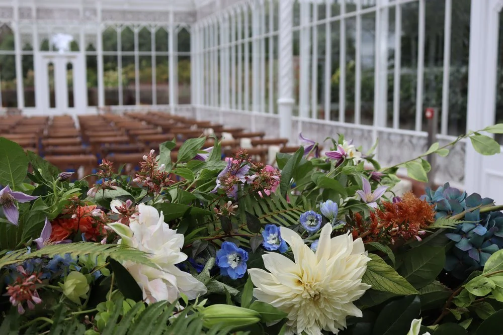 Flowers inside the Horniman Conservatory before a funeral ceremony