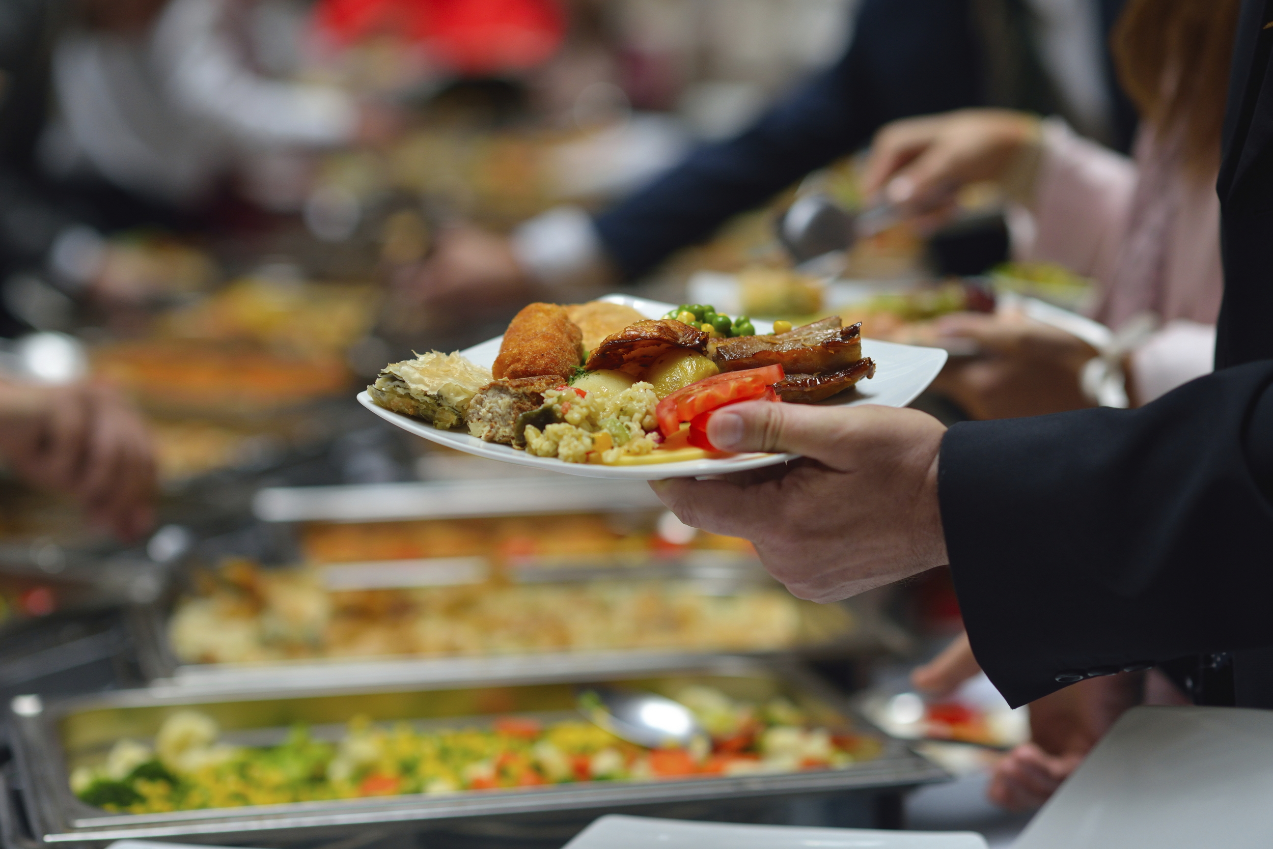 People-in-a-buffet-line-with-full-plates-000024623205_XXXLarge.jpg