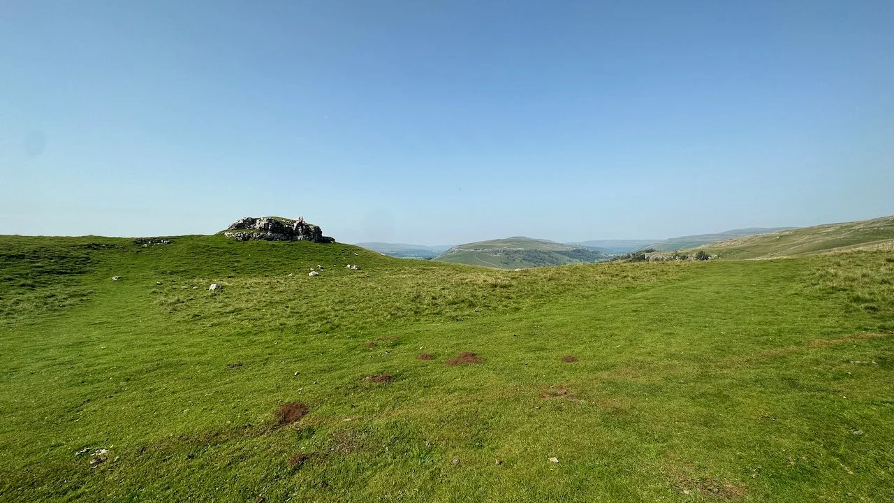  That rocky limestone outcrop is Conistone Pie. Two hikers are on top enjoying their lunch. 