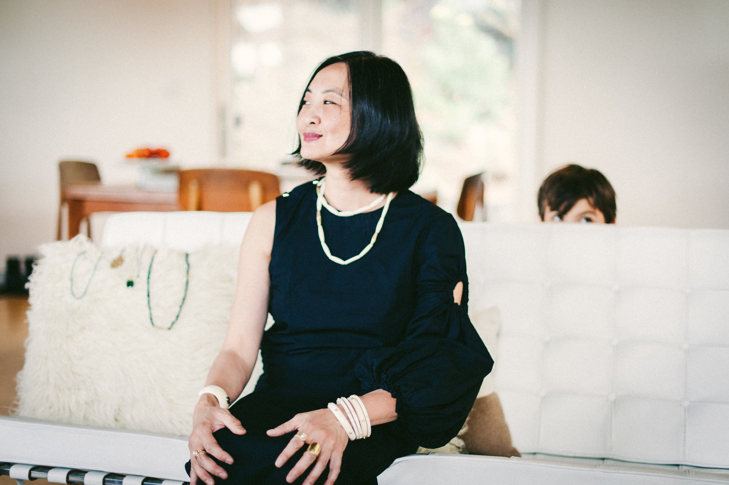   Jill and her son in their home. Jewelry collection by April Higashi.  