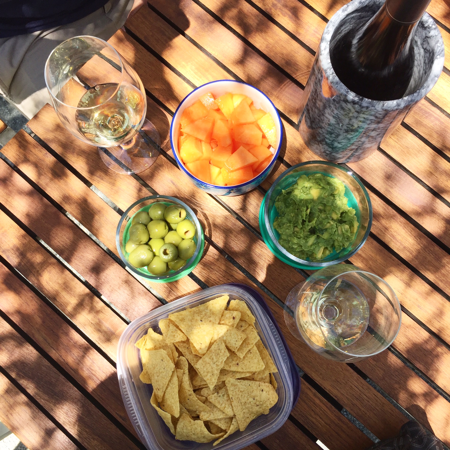 Picnic while wine tasting: tortillas chips, guacamole, green olives, cantaloupe.