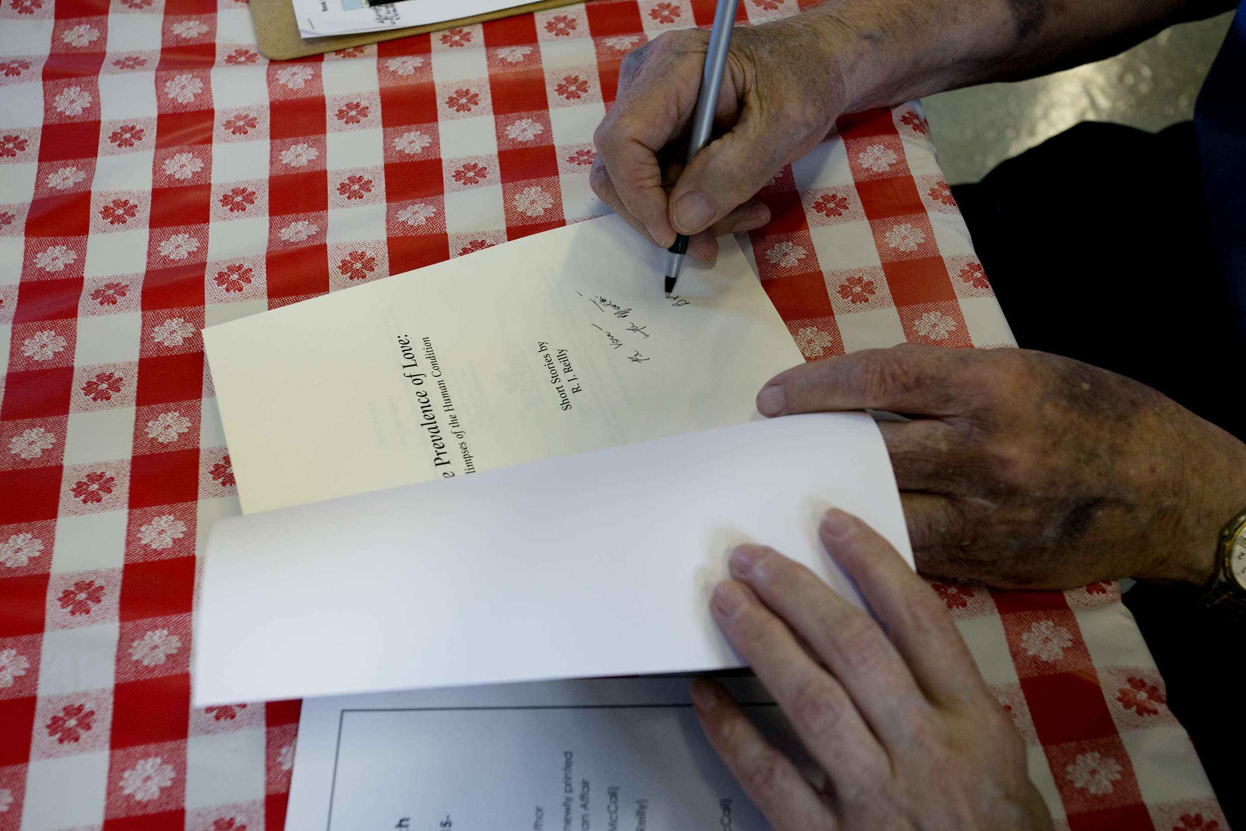 Bob signs a book.jpg