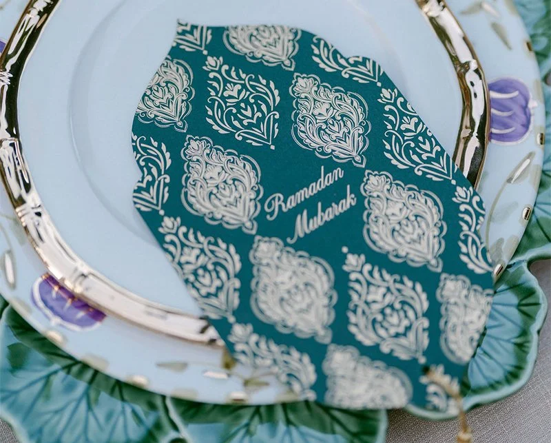 Ramadan menu for corporate event featuring green card with gold pattern and script text by Ananya Cards