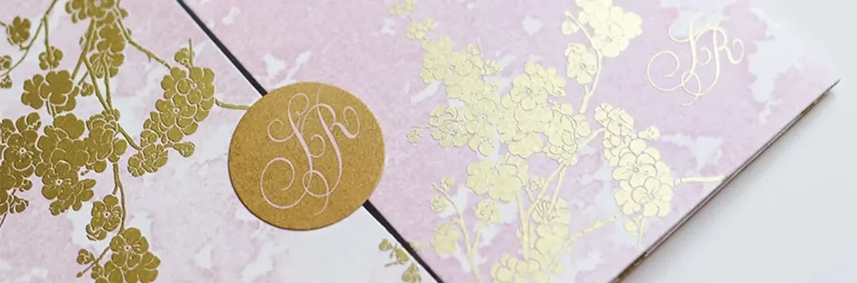 Golden cherry blossom design with watercolour pink background and bespoke monogram seal