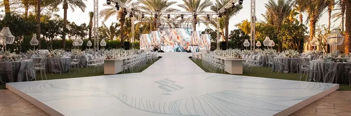 Dancefloor design with bespoke monogram and abstract line detail pattern at an outdoor Dubai wedding