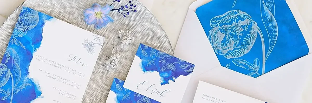 Vibrant blue watercolour wedding stationery with silver flower illustrations