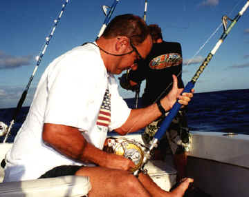 Note the use of the left thumb to guide the line