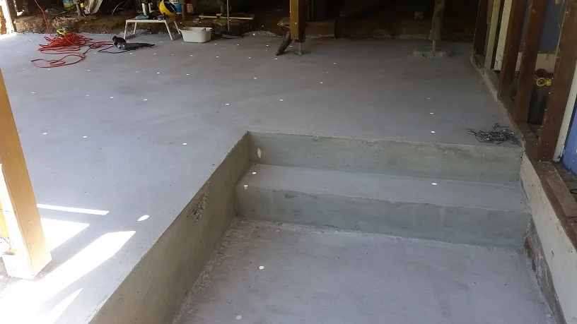 Split level concrete floor and step after removal of formwork.