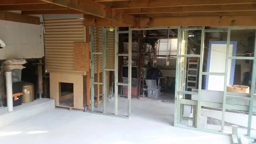 this! integrated dog kennel, functional split level concrete floor, concrete retainer barrier left of photo, internal stud walls creating separate carport, work area, and the end result ....