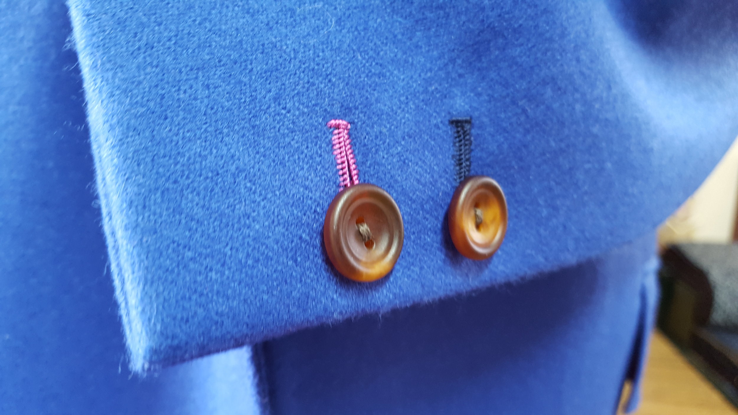 We decided to go with a handmade buttonhole (with contrasting thread to match the lining). Factory made jackets will usually have a machine made button hole but a handmade buttonhole is something that little bit special.