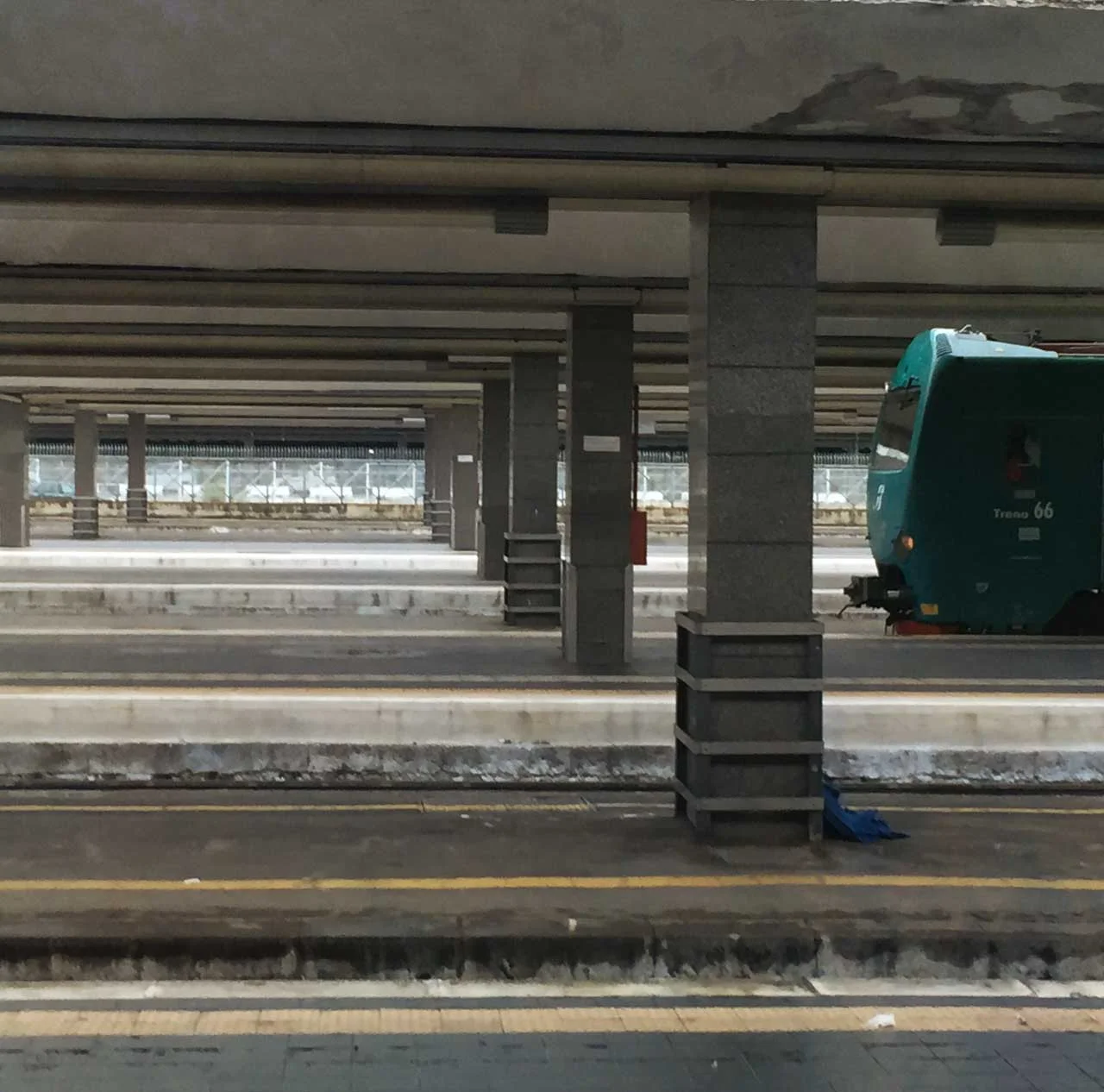 green train approaching Naples Station