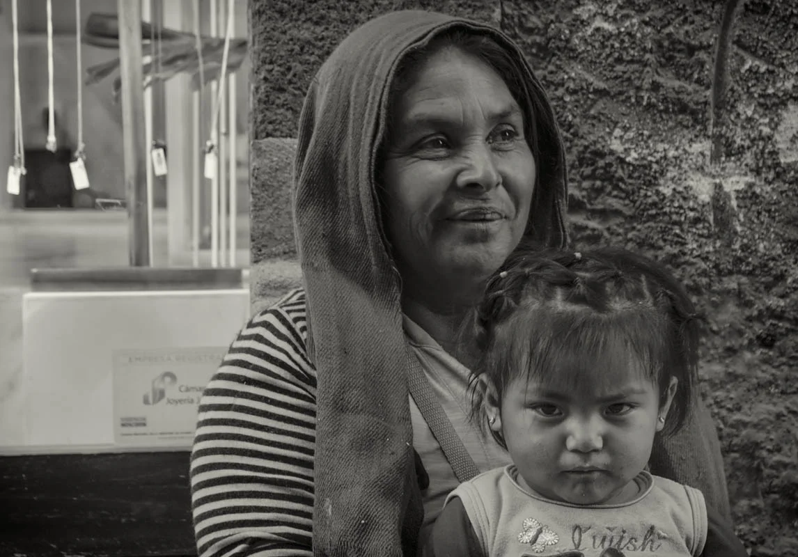 Woman and child begging in front of jewelry store
