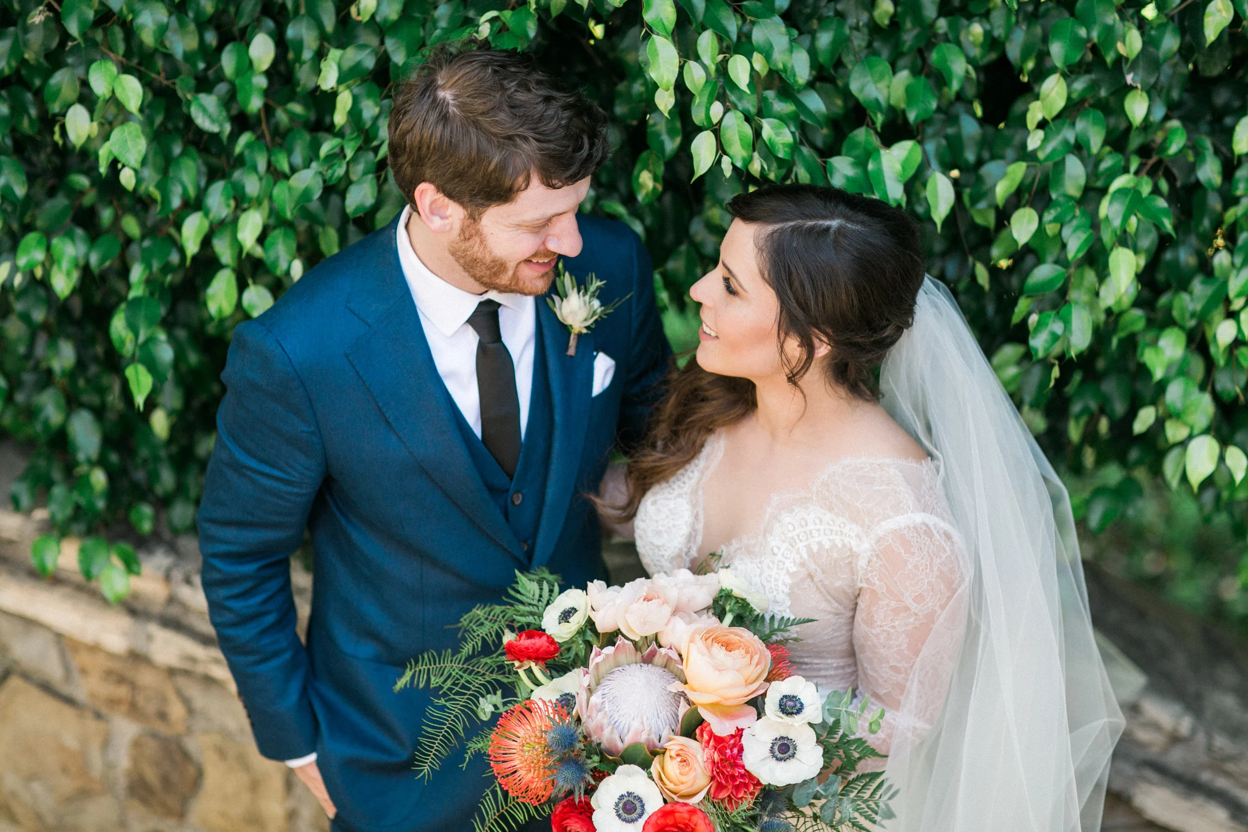 King Protea Bouquet, Blue Thistle, Anemone, Fern, Ranunculus, Pincushion Protea, & Garden Roses, Bel Air Bay Club, Art & Soul Events, Bright & Bold Tropical Beach Wedding Bouquet, Blue Groom Suit