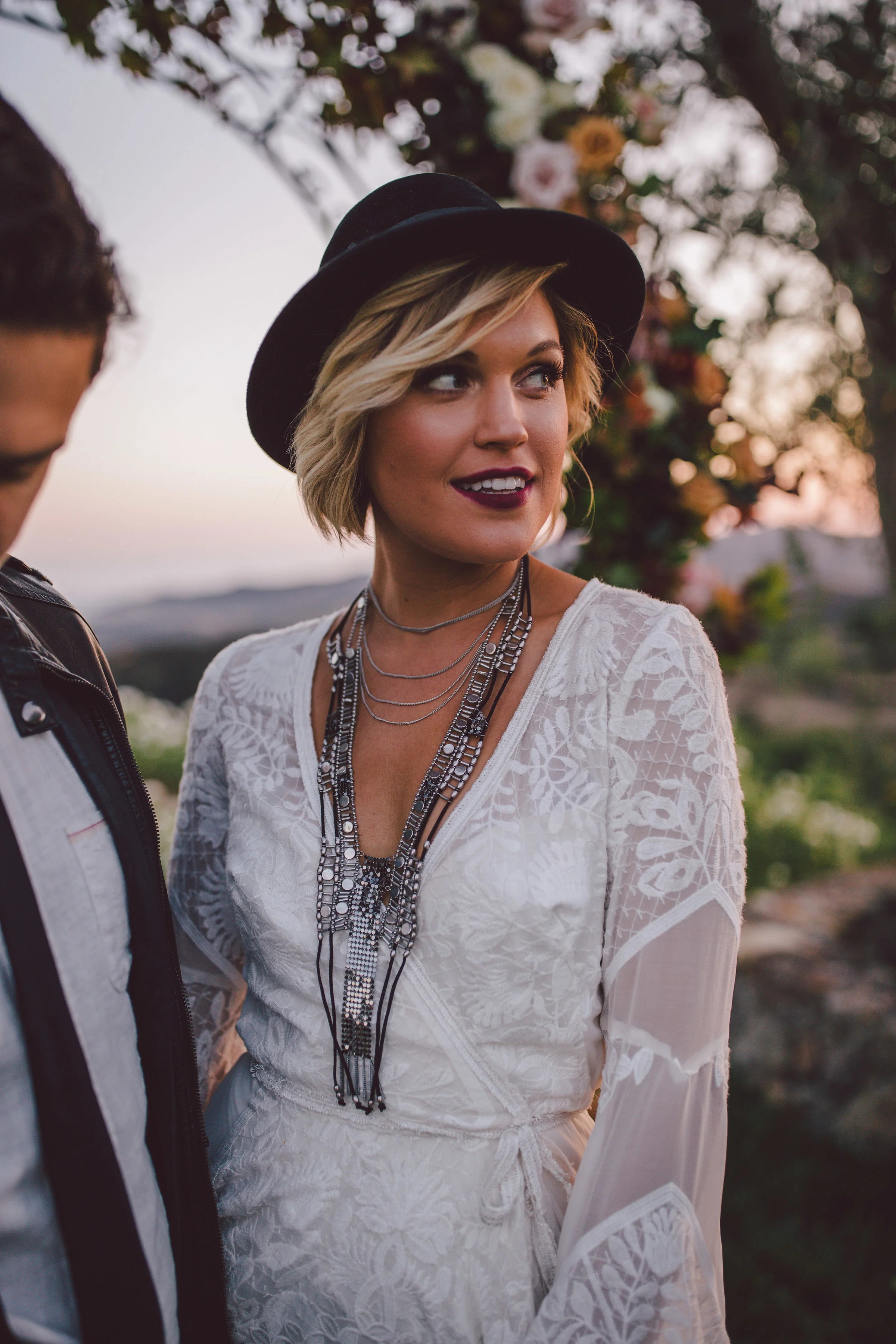 boho bride wearing a black hat