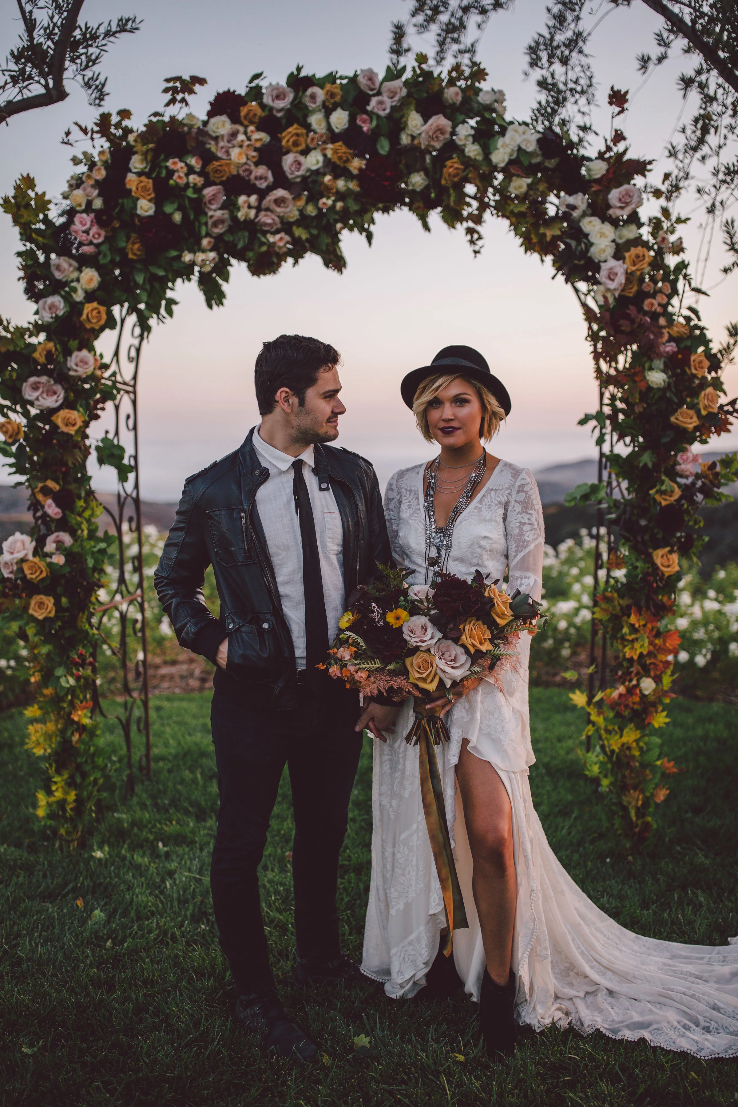 Edgy boho bride and groom moody fall ceremony arch