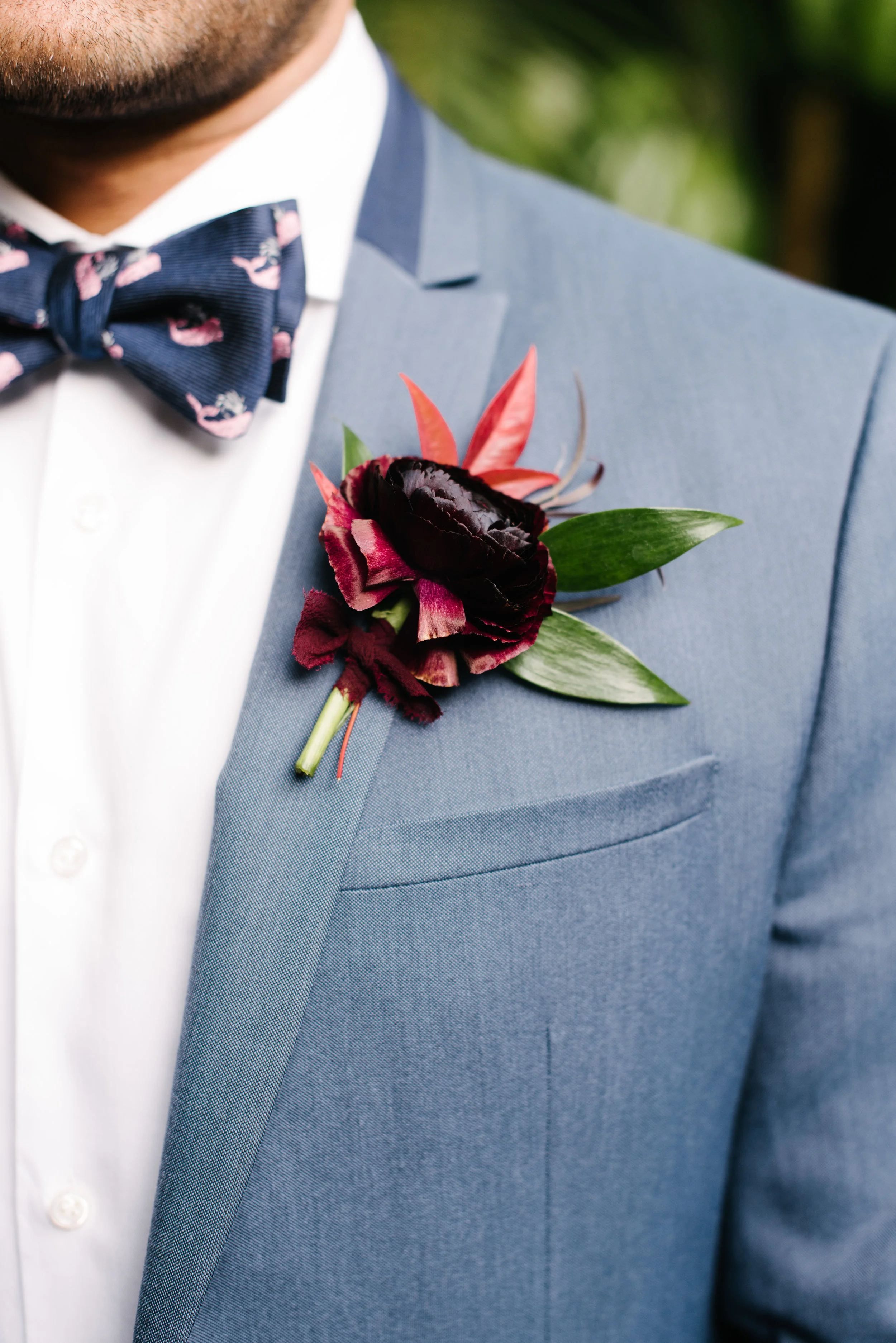 Moody fall groomsmen boutonniere with warm fall tones. Chocolate ranunculus