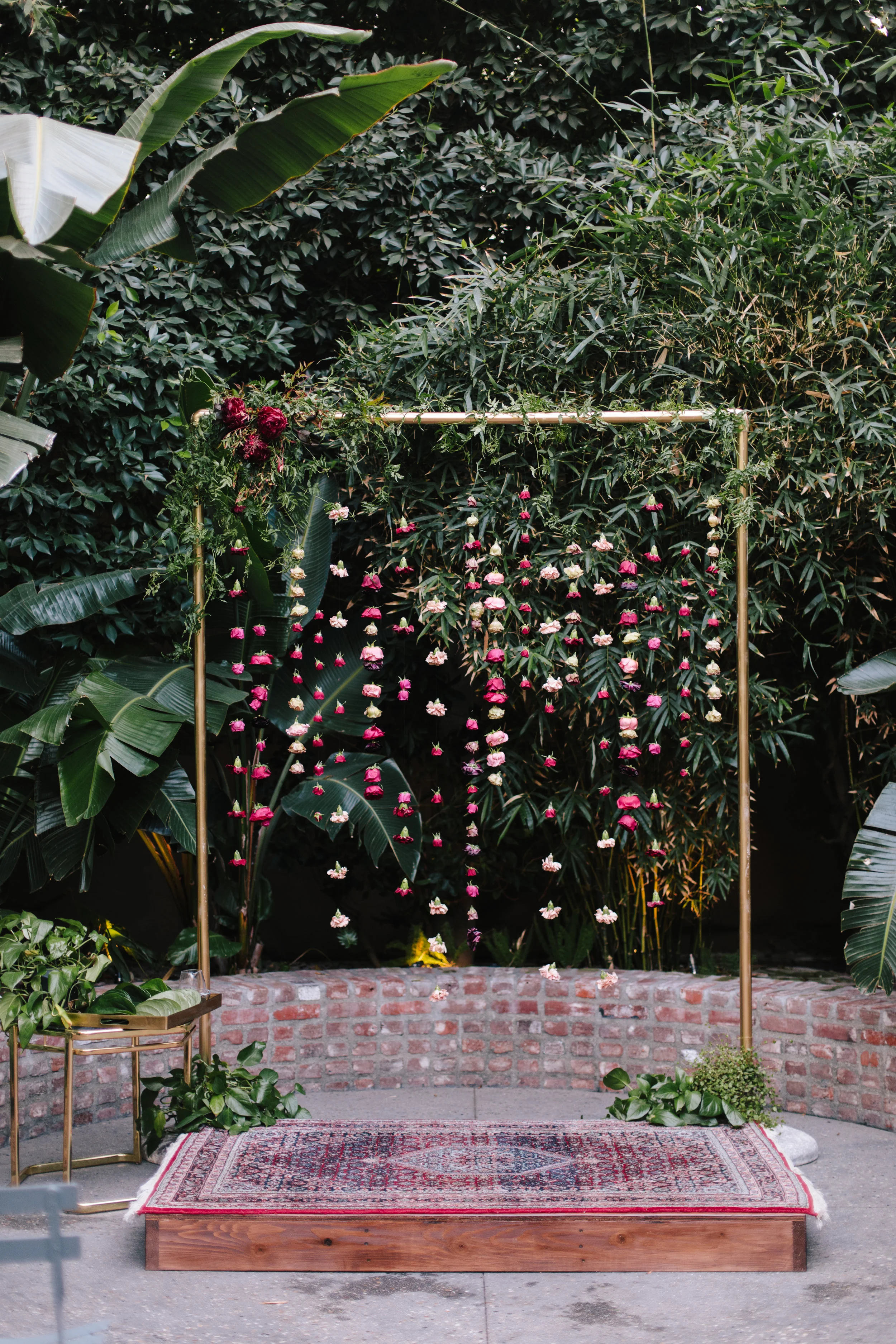 Sri Lankan-Buddhist fusion Millwick wedding ceremony with betel leaves, a colorful hanging floral altar, and a custom wood poruwa