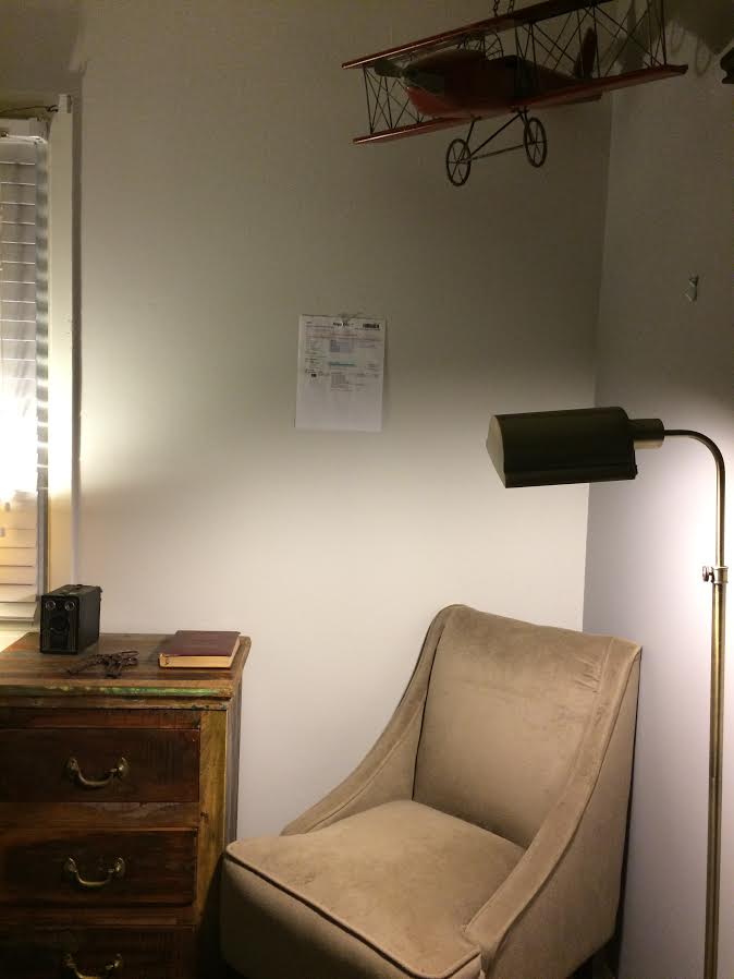 CORRECT - paper taped to the wall, head on shot, furniture visible.