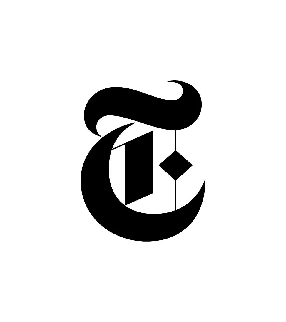 Stylized black letter 'T' with a diamond shape hanging from its center, resembling a key or ornament.