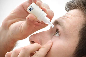man-uses-eye-drop-330x220.jpg