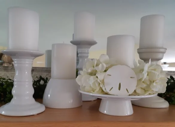 In this display I’ve used both a plant pot and a pedestal plate to provide height. Note the texture in the candle sticks as well which brings some visual interest.