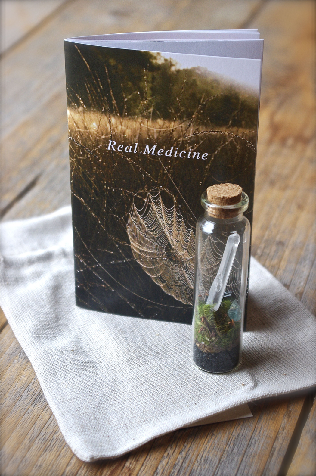 Gift Sets include your chosen booklet, token terrarium, & linen pouch.