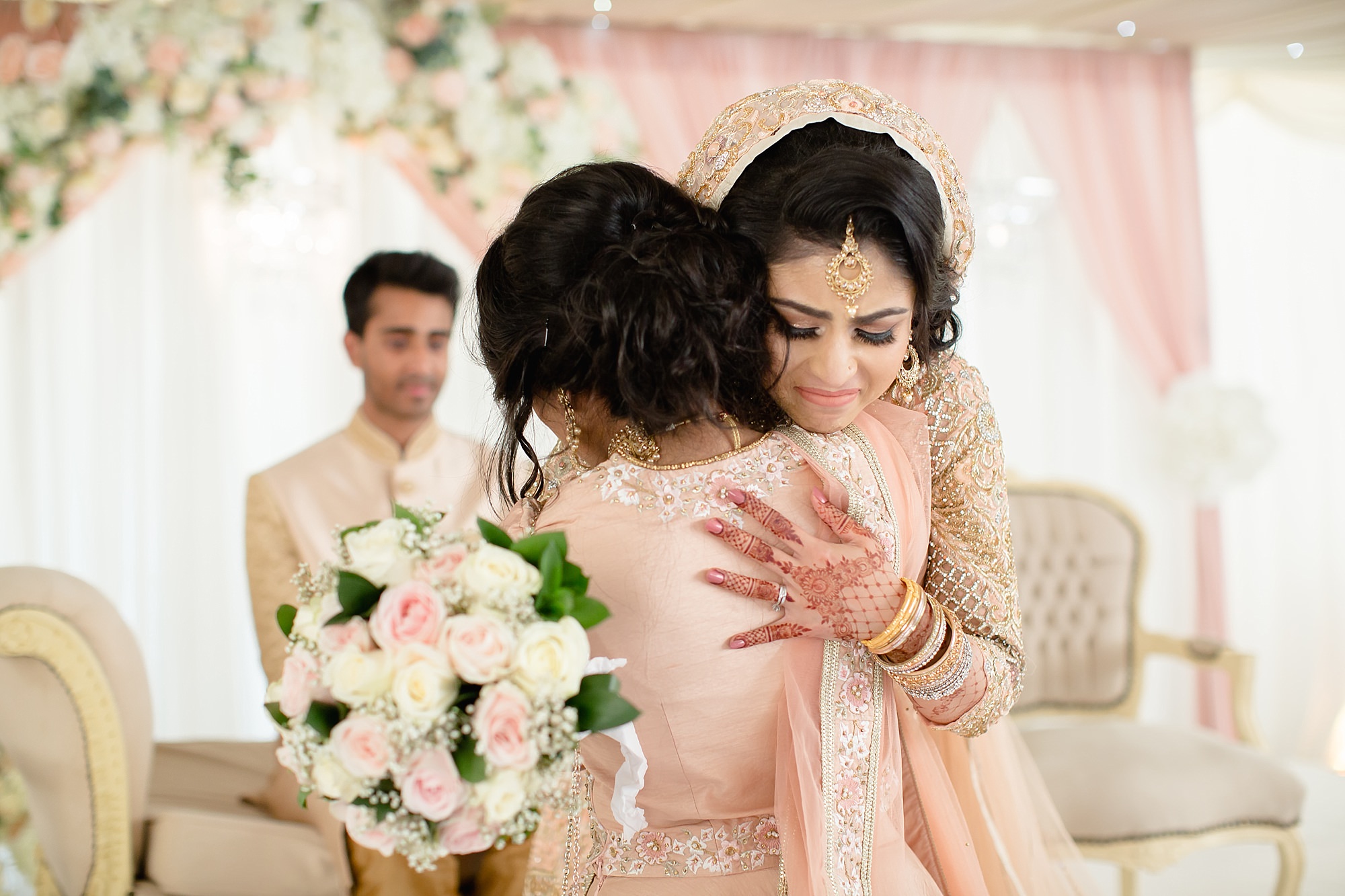 Bride and sister hug at Hilton Hall Wolverhampton
