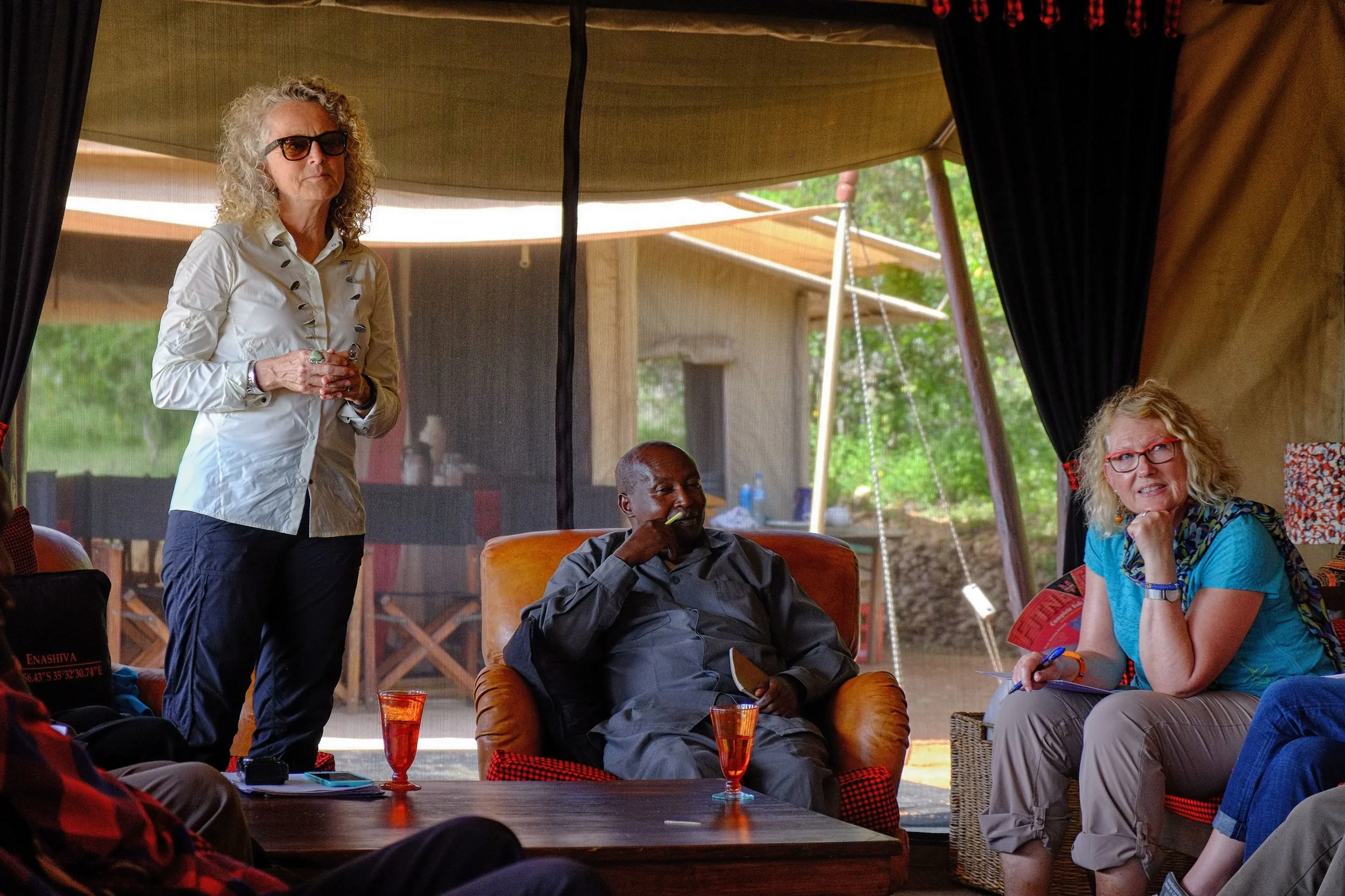 Board Members Judi Wineland and Karen Dial sit on either side of Ward Councilor for the Oloipiri Ward, William Alias during a meeting with Oliopiri Elders. 