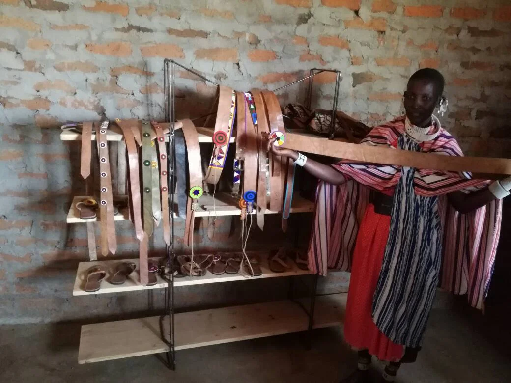 This COCOBA woman shows off her leather goods.