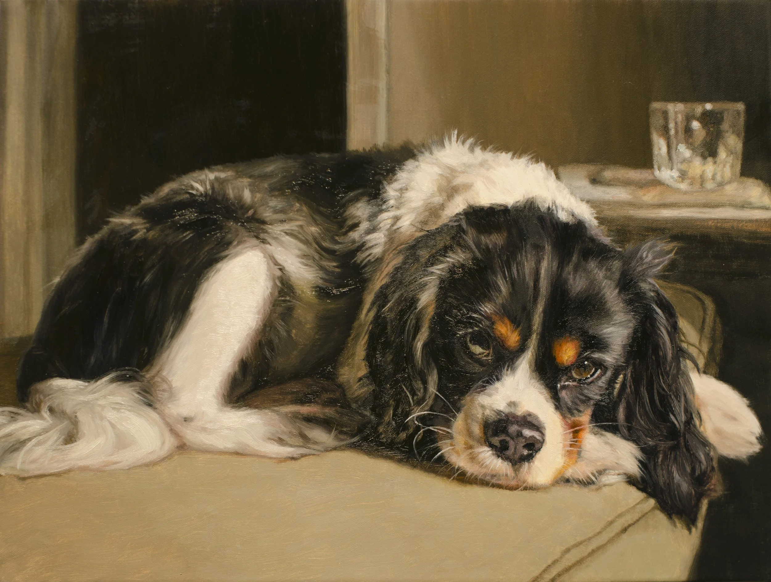 An oil painted custom portrait of a black-and-white Cavalier King Charles Spaniel resting on a couch cushion. Exquisitely detailed. 