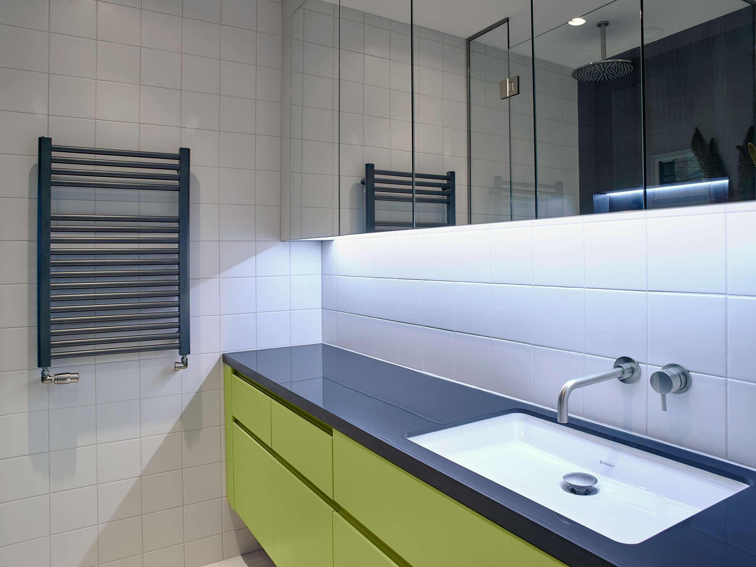 A glossy Corian surface with in-set bathroom maximises countertop space.