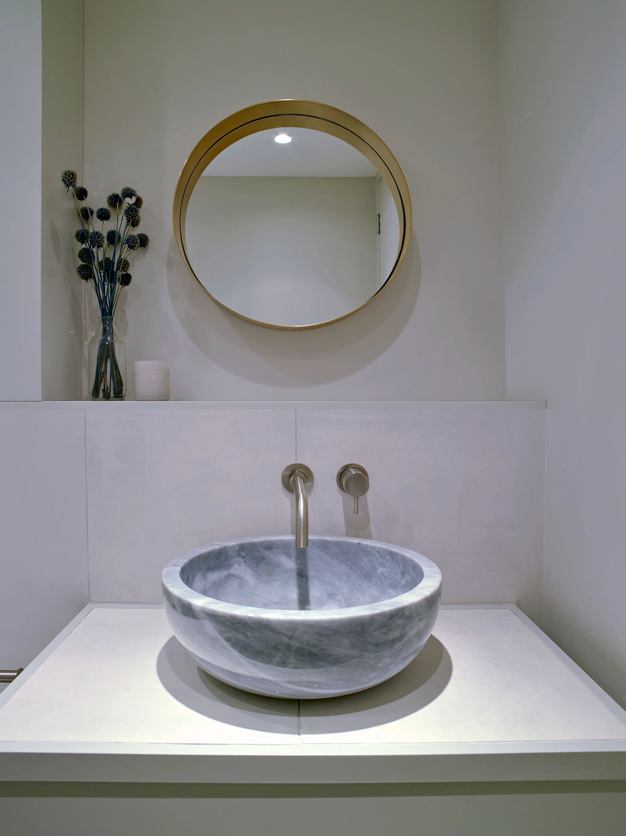 In the main bathroom, a one of a kind honed marble basin takes pride of place. 