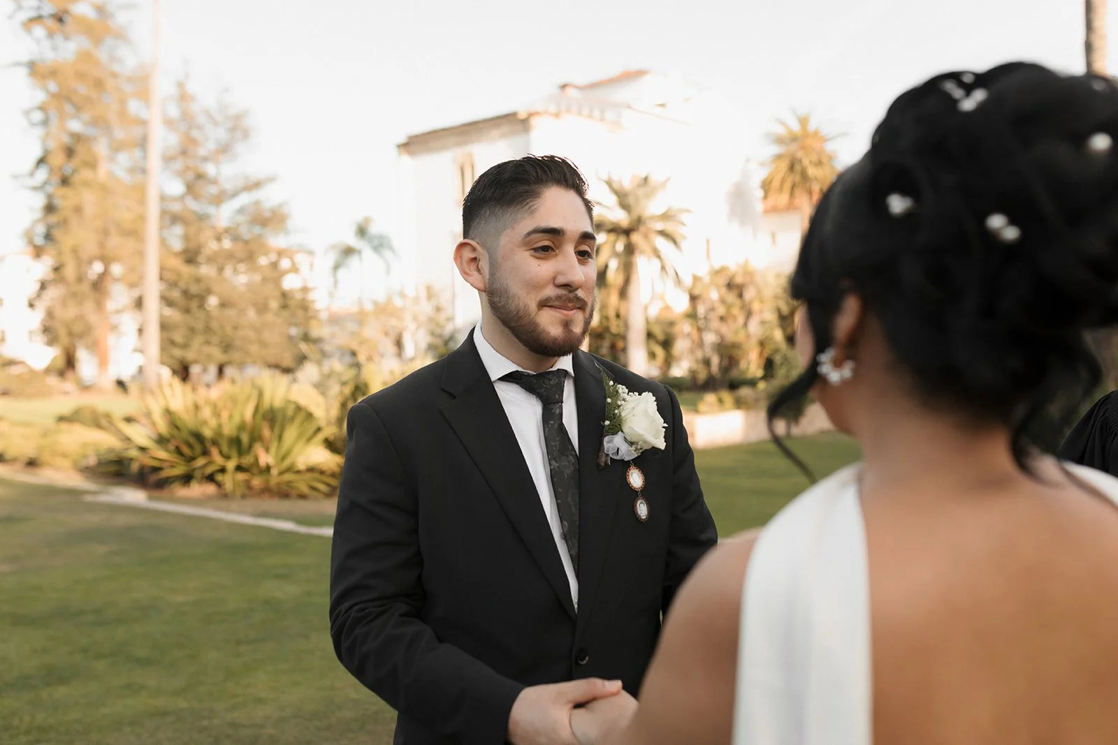 Bride’s POV of groom looking at her during elopement ceremony at the Santa Barbara Courthouse Sunken Gardens