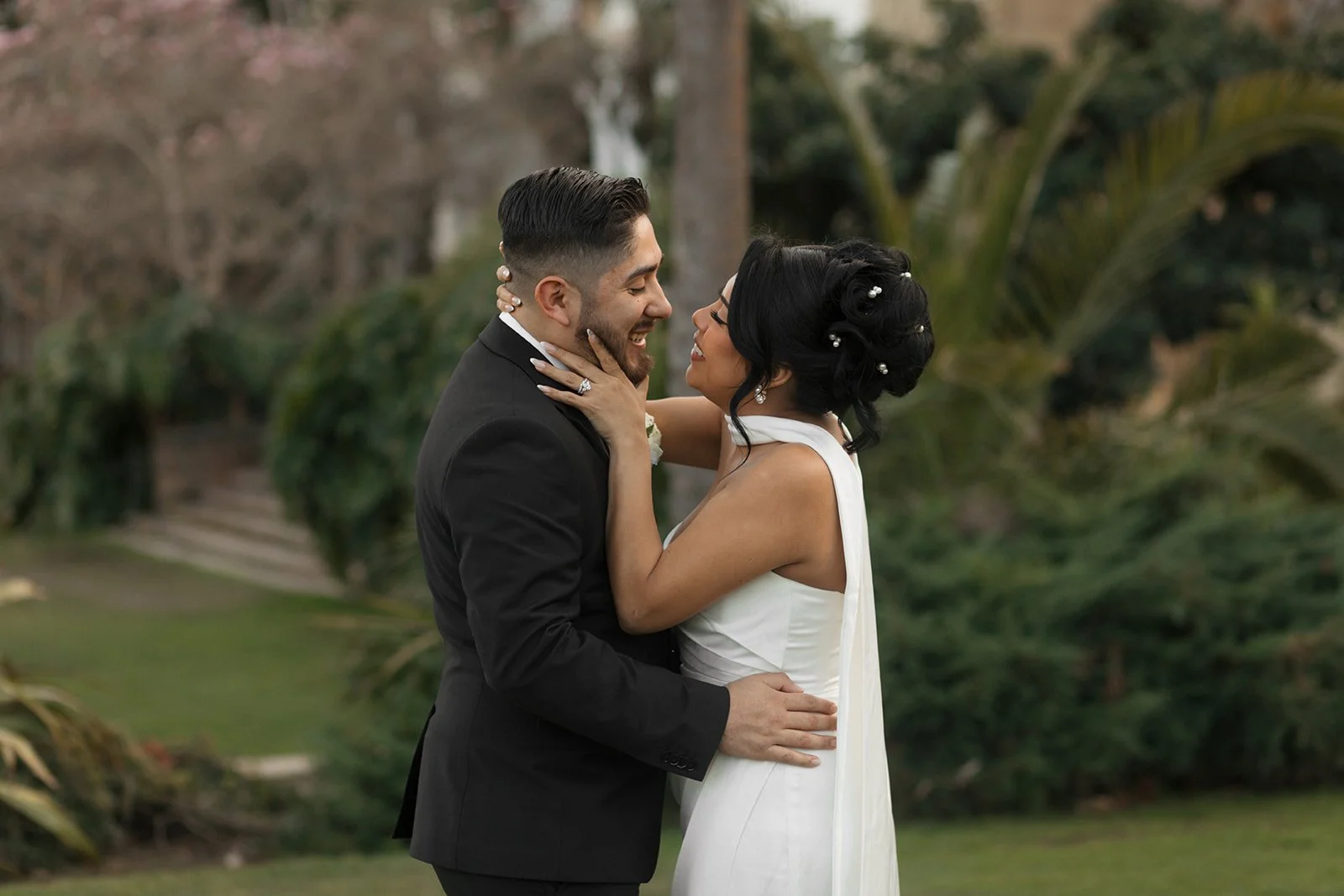 Couple embracing in the moment just before a kiss during elopement ceremony at the Santa Barbara Courthouse Sunken Gardens