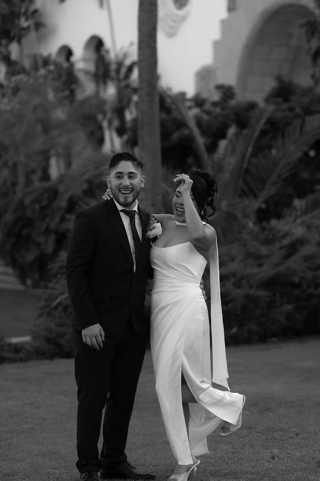 Black and white candid of couple celebrating after being announced married during elopement ceremony at the Santa Barbara Courthouse Sunken Gardens