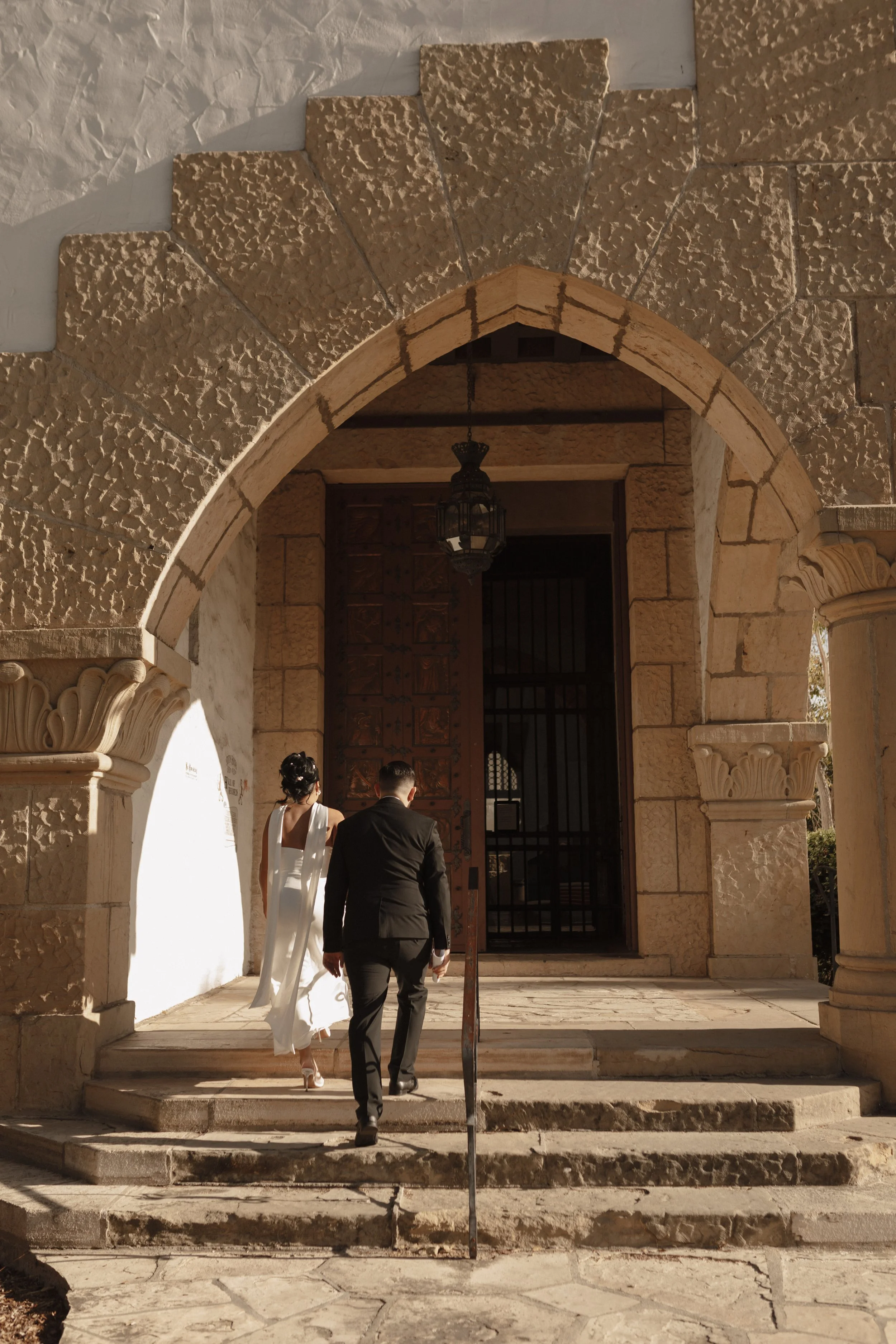 Couple walking into the Hall of Records at the Santa Barbara Courthouse for their elopement ceremony