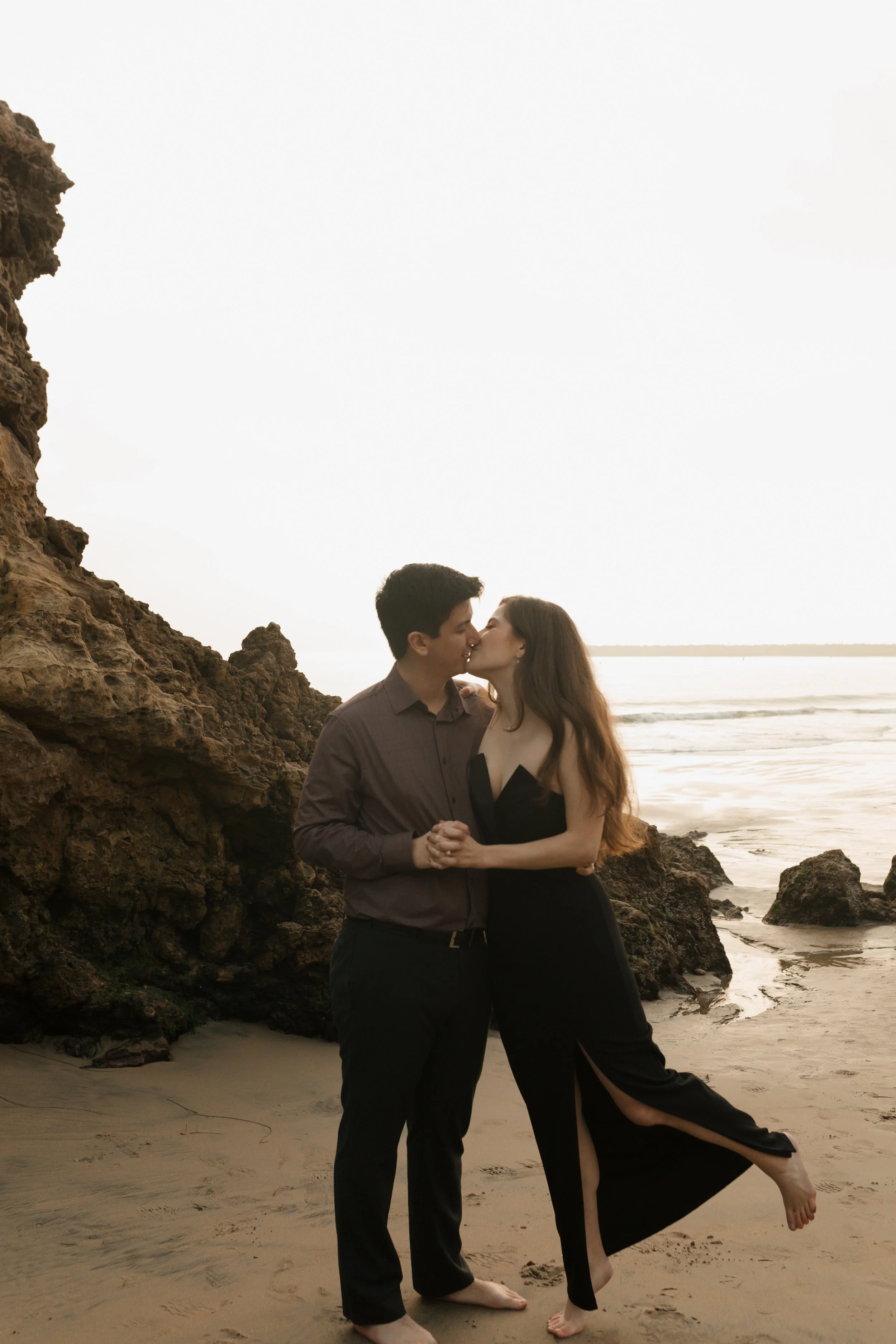 couple leaning into kiss from proposal in Newport Beach