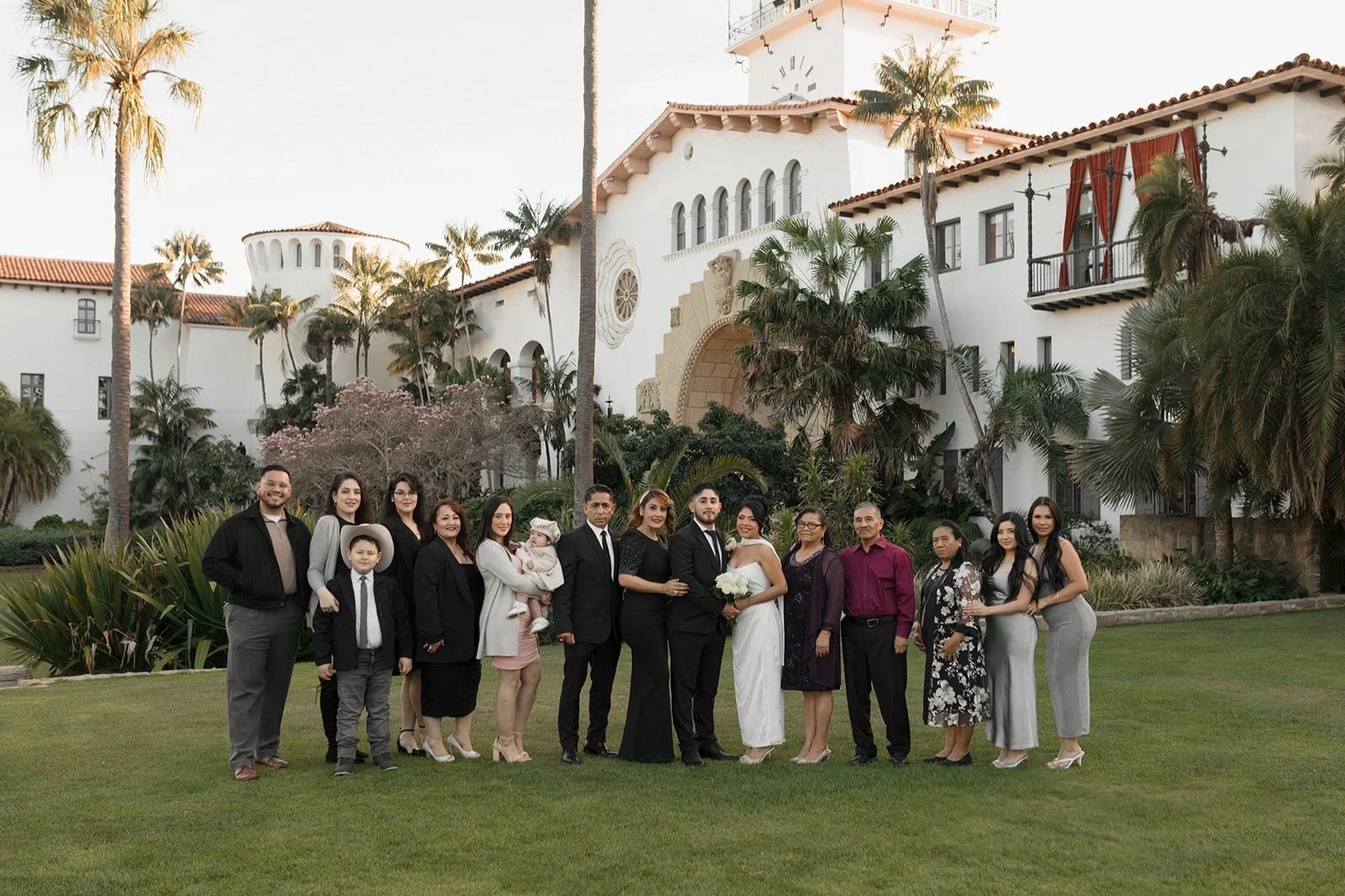 Family photo with bride and groom at the Santa Barbara Courthouse Sunken Gardens after their elopement ceremony