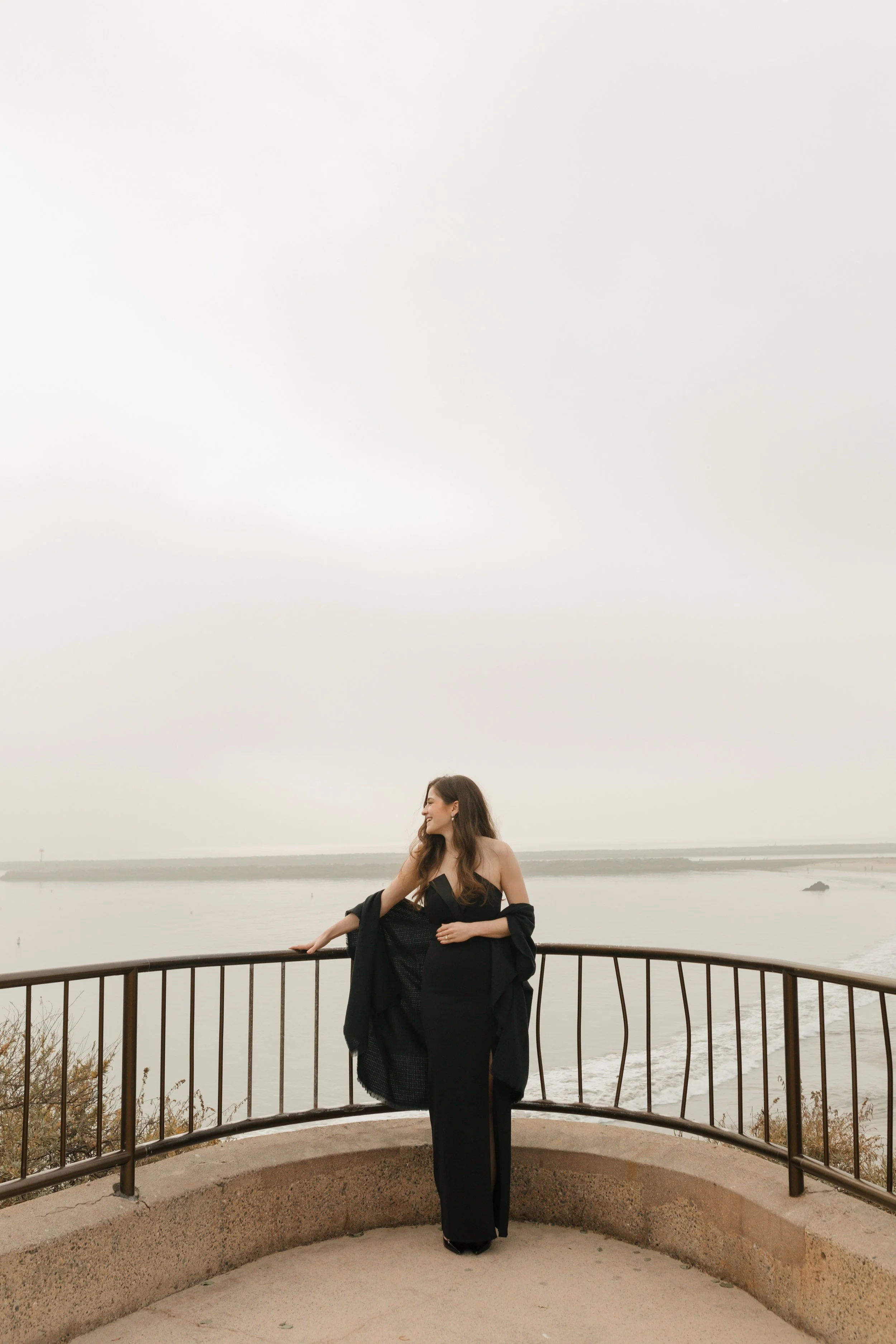girl posing looking away from camera from the proposal at lookout in newport beach with the ocean in background