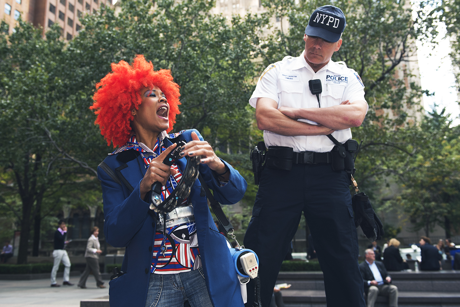 An NYPD officer keep watching over an anti-abuse of climate demonstrator on Park Avenue, Manhattan. 2015 © Go Nakamura photography