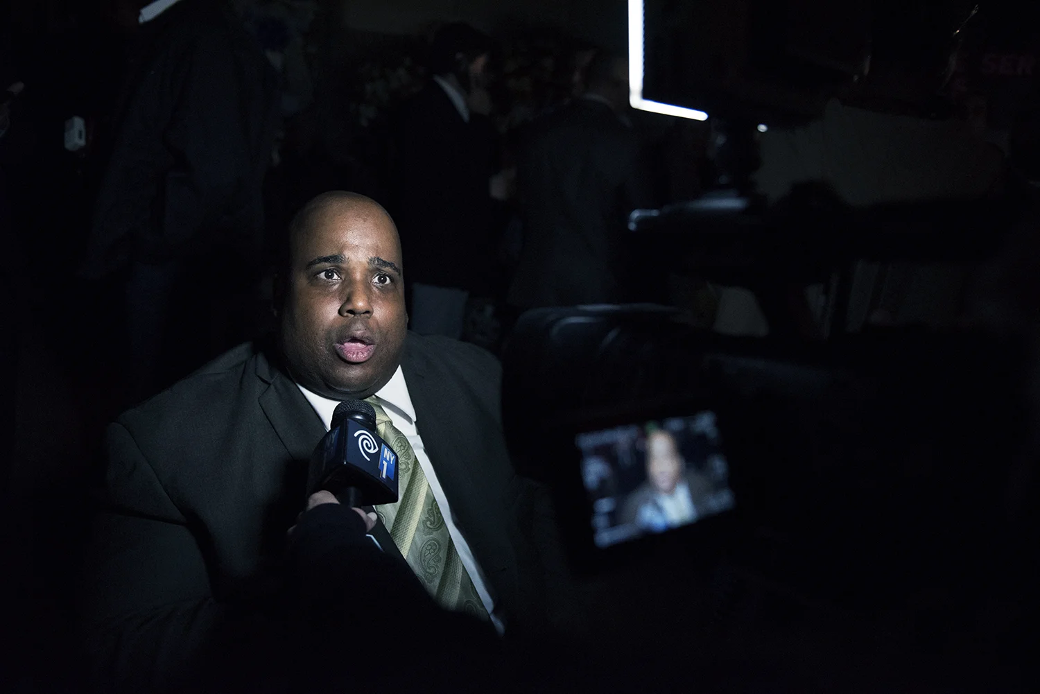 a mourner giving a comment to medias outside the Police Service Area 5 station house, paying his respect to the slain NYPD Officer Randolph Holder who was killed in action on the night of October 20. East Harlem, Manhattan. 2015 © Go Nakamura photography