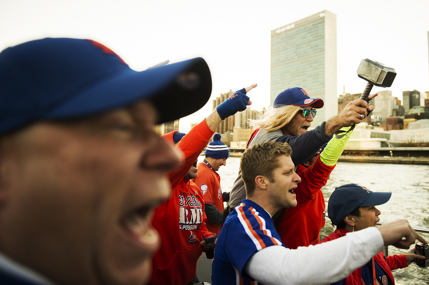 New York Mets fans get excited as they take a ride on Water Taxi to Citi Field to see Mets play for World Series. East River, NY. 2015 © Go Nakamura photography