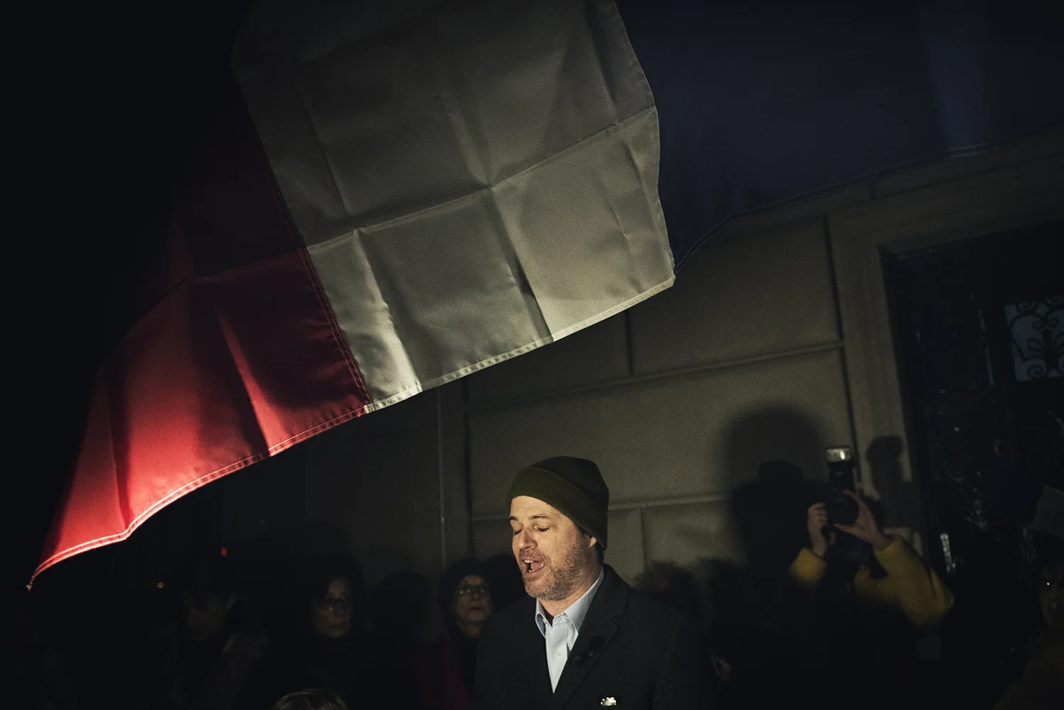 A Brooklyn man, an activist, giving a speech at outside of Consulate General of France in Manhattan to pay tribute for the victims of terror attack in Paris. 2015 © Go Nakamura photography