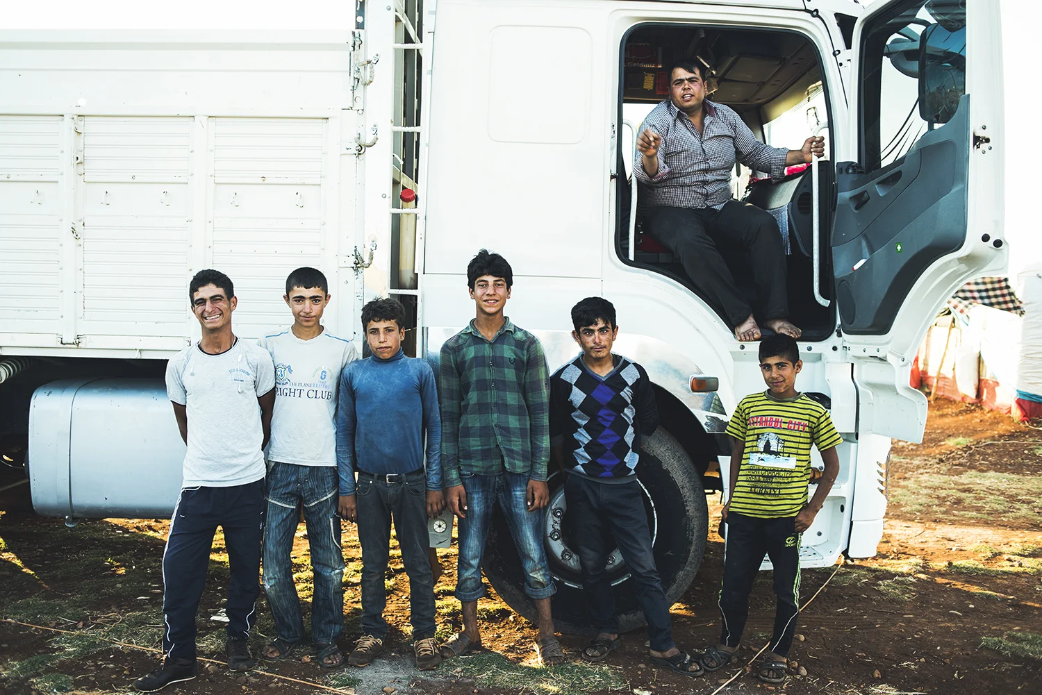 Kurdish young men in their informal camp located at outskirts of Reihanli, Turkey. 2015 © Go Nakamura photography