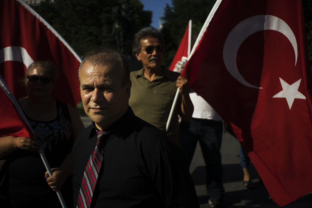 a small group of demonstrators raise Turkish flags in Union Square to protest against recent terror attacks in Turkey. Manhattan, NY. 2016 ©Go Nakamura photography