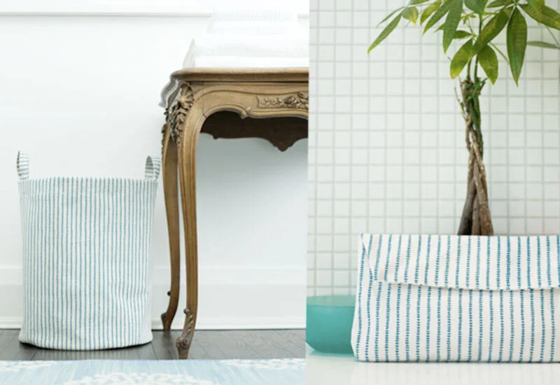 Divided image showing a laundry basket on the left and a potted plant on the right, each with a blue and white vine pattern designed by Gen Burgess for Lovell Designs.
