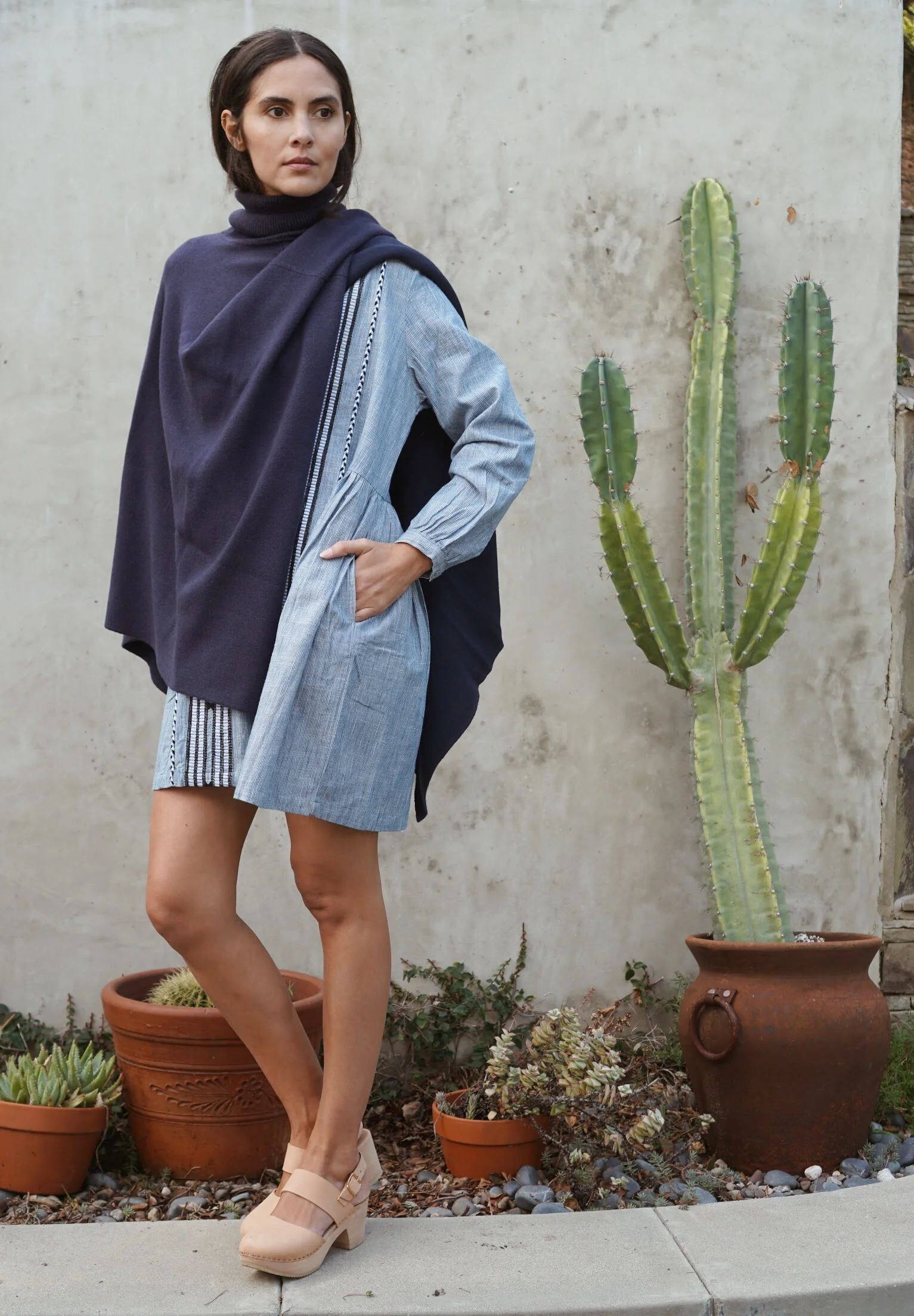 Kopal Riya Dress in Indigo Stripe + Maiyet Double Knit Cape in Navy + Zuzii Closed Toe Clogs in Natural.